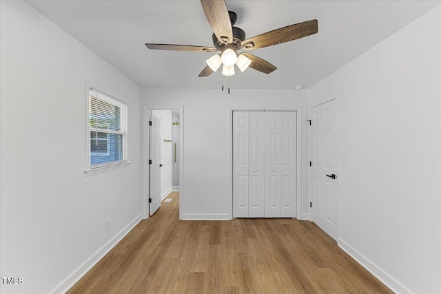 unfurnished bedroom with a closet, light wood-type flooring, and ceiling fan