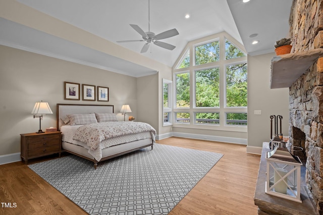 bedroom with ceiling fan, hardwood / wood-style flooring, lofted ceiling, and crown molding