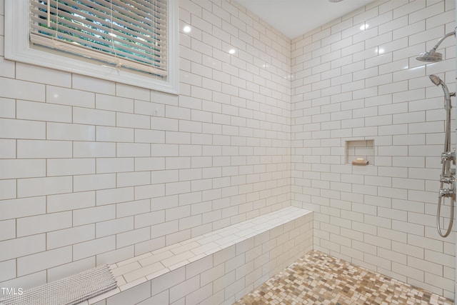 bathroom with tiled shower