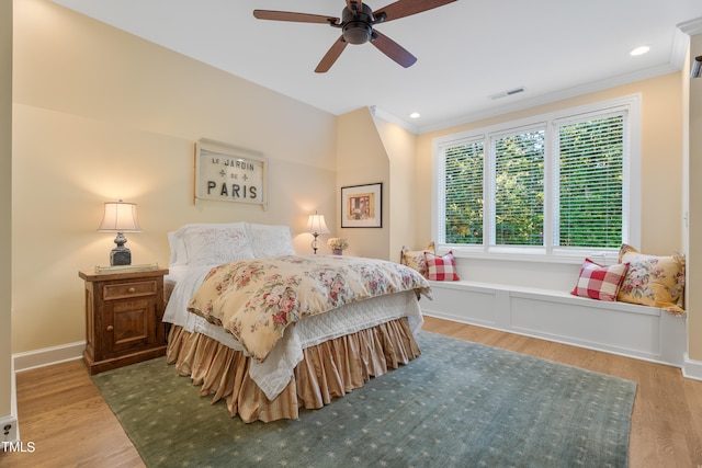 bedroom featuring ornamental molding, hardwood / wood-style flooring, and ceiling fan