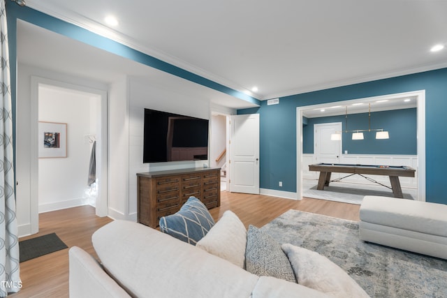 living room with ornamental molding and hardwood / wood-style floors