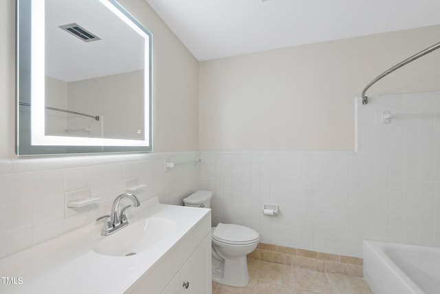 full bathroom with vanity, bathtub / shower combination, tile patterned floors, tile walls, and toilet