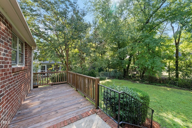 wooden deck featuring a yard