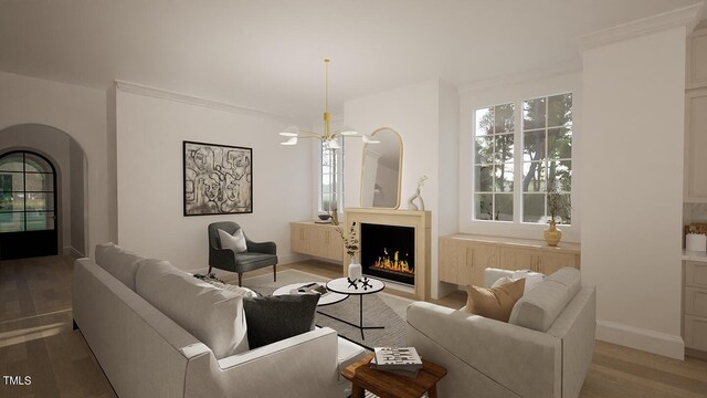 3301 Dell Dr, Raleigh, NC 27609 - living area featuring ornamental molding, arched walkways, a warm lit fireplace, and light wood-style floors