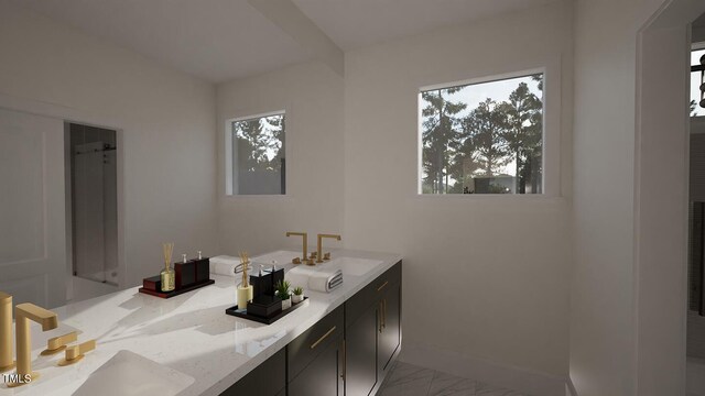 3301 Dell Dr, Raleigh, NC 27609 - bathroom with baseboards, marble finish floor, double vanity, and a sink