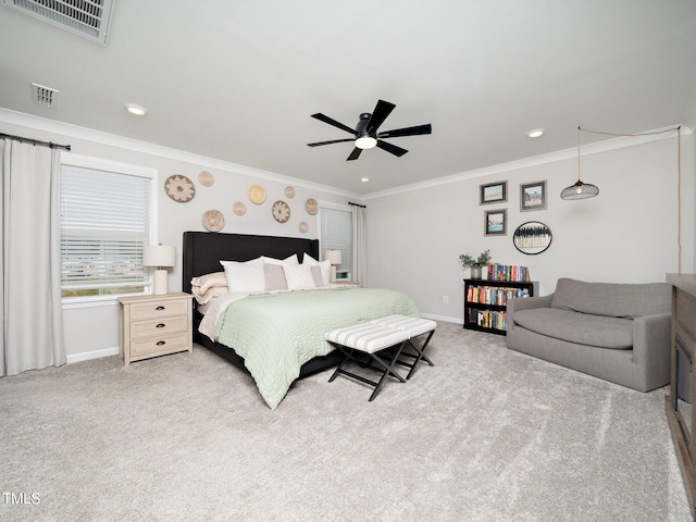 bedroom with crown molding, baseboards, visible vents, and light colored carpet