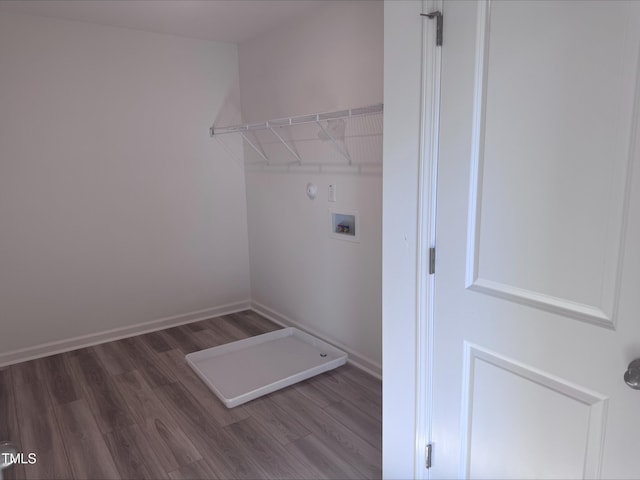 clothes washing area with hardwood / wood-style floors and hookup for a washing machine