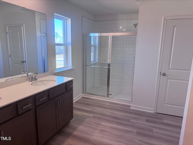 bathroom featuring hardwood / wood-style floors, vanity, and walk in shower