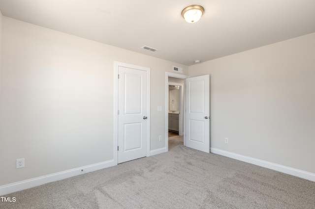 unfurnished bedroom featuring light colored carpet