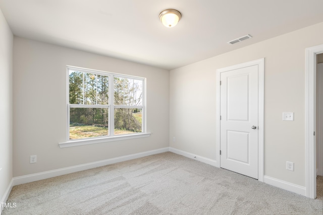 empty room featuring light colored carpet