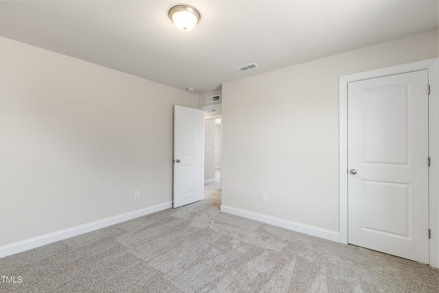 unfurnished bedroom featuring light colored carpet