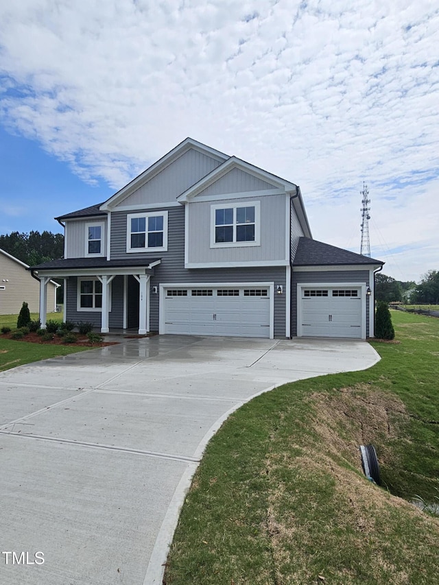 traditional home featuring a porch, a front lawn, a garage, and concrete driveway
