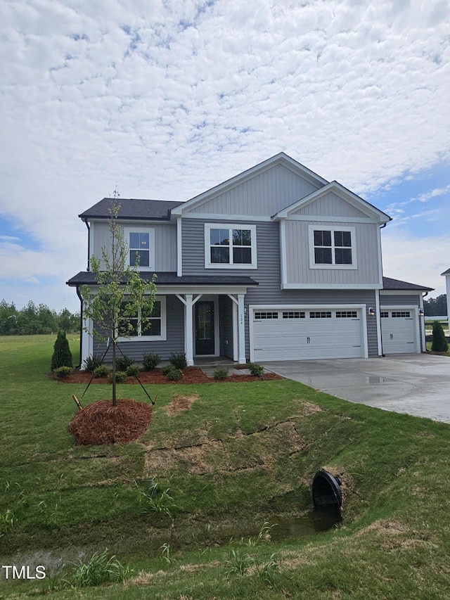 traditional-style house with concrete driveway, a garage, a front yard, and covered porch