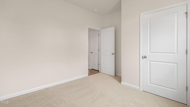 unfurnished bedroom with baseboards and carpet flooring