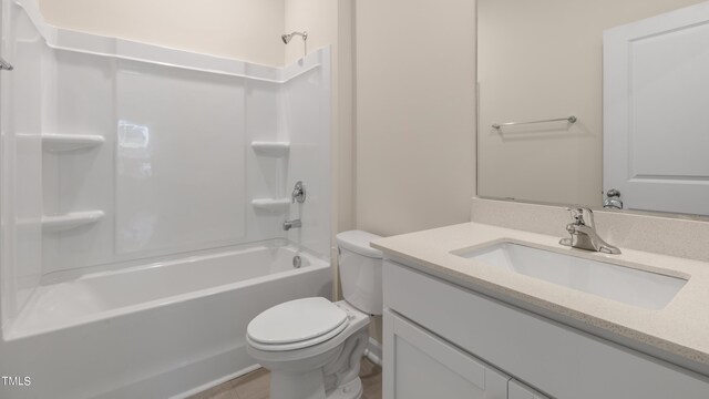 bathroom featuring toilet, vanity, and bathtub / shower combination