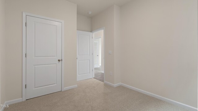 unfurnished bedroom featuring carpet and baseboards
