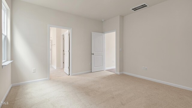 unfurnished bedroom featuring baseboards, visible vents, and carpet floors