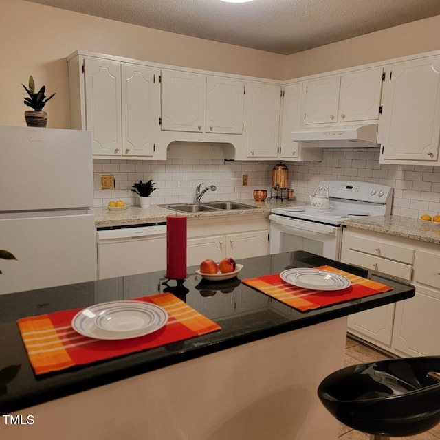 kitchen with white cabinets, white appliances, and backsplash