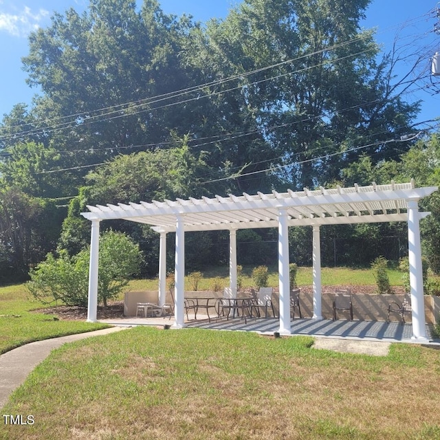 view of community with a pergola, a yard, and a deck