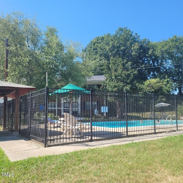 view of pool featuring a yard