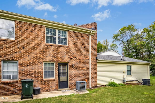 back of house featuring cooling unit and a yard