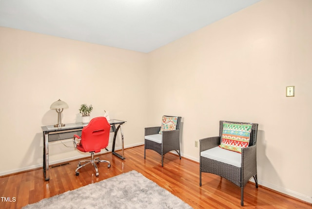 home office with hardwood / wood-style flooring