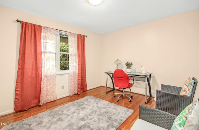 home office with hardwood / wood-style floors