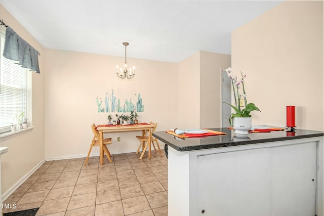 kitchen featuring hanging light fixtures, light tile patterned flooring, and a chandelier