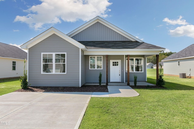 view of front of property featuring a front lawn and central AC unit