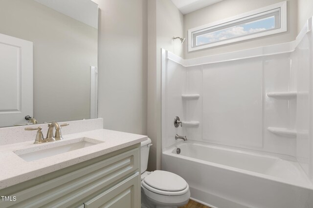 full bathroom featuring bathing tub / shower combination, vanity, and toilet