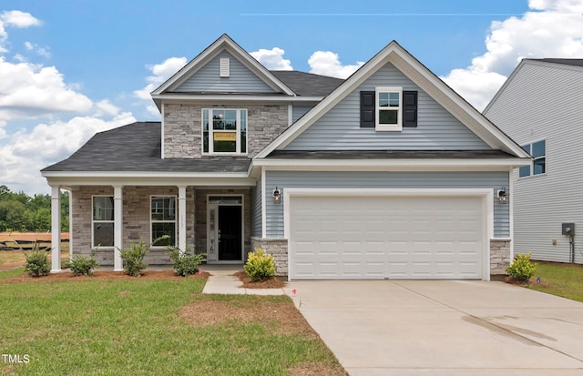 craftsman house with a porch, a front lawn, and a garage