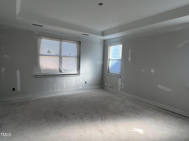 unfurnished room with a tray ceiling