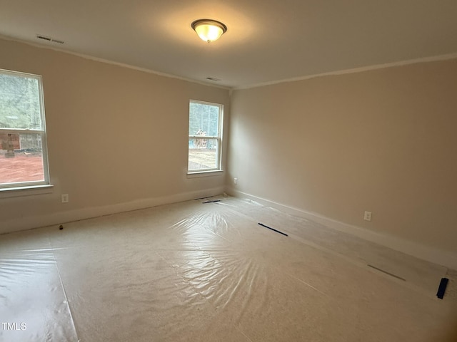 spare room with crown molding