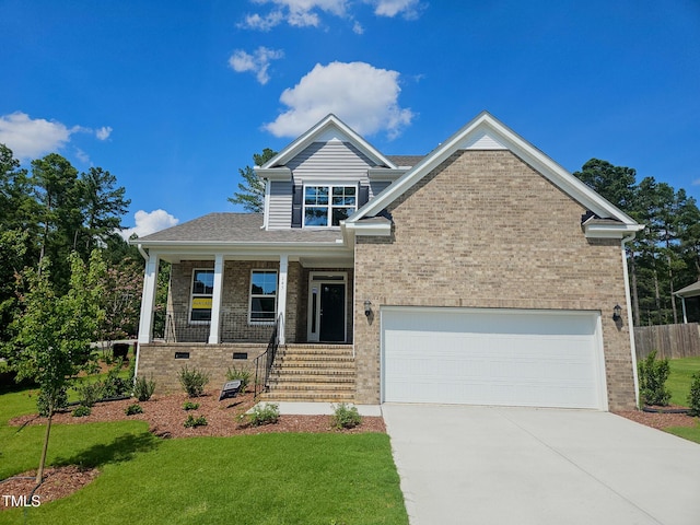 145 Green Haven Blvd Lot # 83, Youngsville, NC 27596 - view of front of property with brick siding, driveway, a front yard, covered porch, and an attached garage