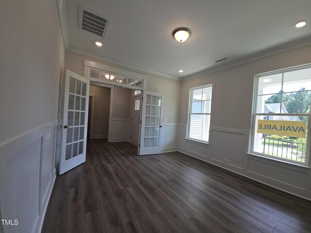 145 Green Haven Blvd Lot # 83, Youngsville, NC 27596 - empty room with french doors, dark wood finished floors, wainscoting, ornamental molding, and recessed lighting