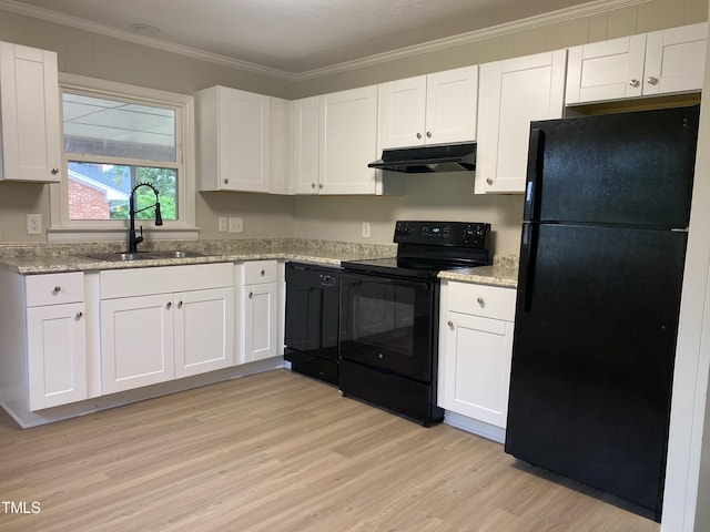 kitchen featuring white cabinets, crown molding, sink, and black appliances