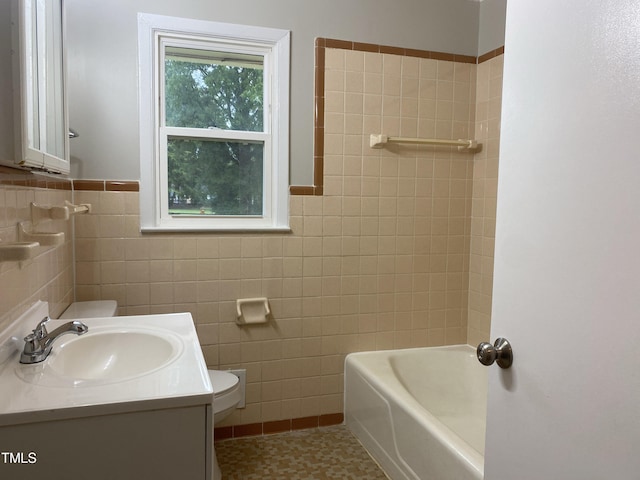 bathroom with vanity, tile walls, tile patterned flooring, and toilet