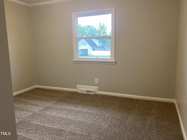 carpeted empty room featuring crown molding