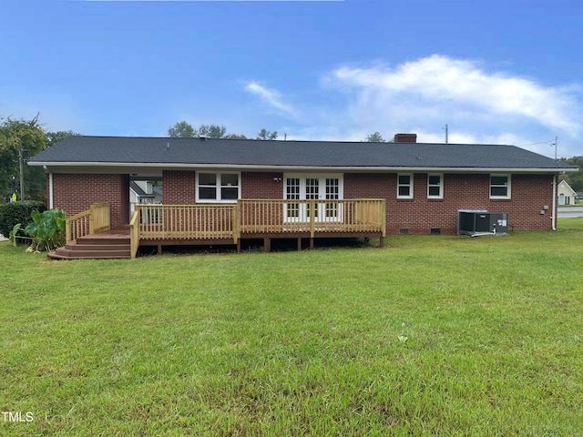 back of house with a deck, a lawn, and central air condition unit