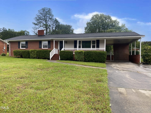 ranch-style house with a front yard, covered porch, and a carport