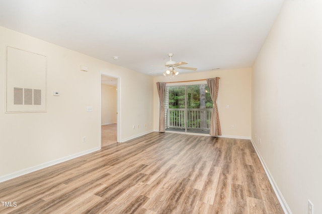 spare room featuring light hardwood / wood-style flooring and ceiling fan