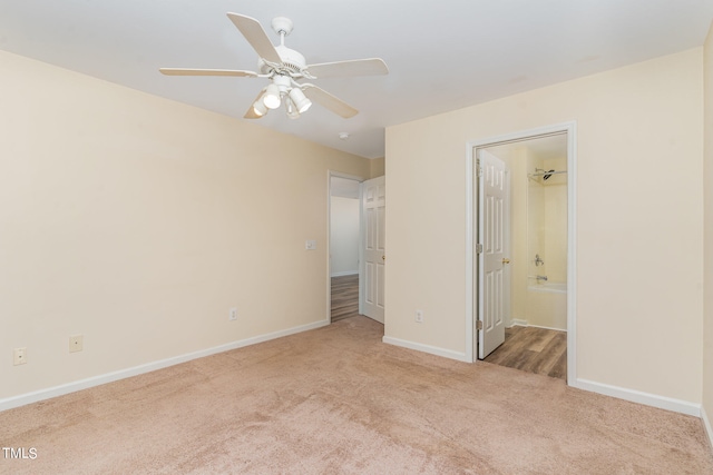 unfurnished bedroom with light colored carpet, ceiling fan, and ensuite bathroom