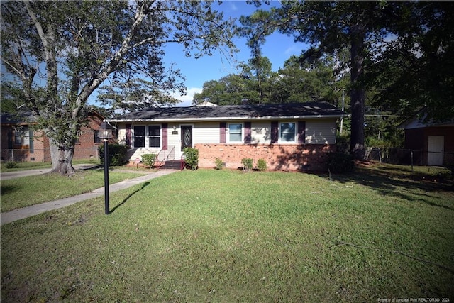 ranch-style home featuring a front yard