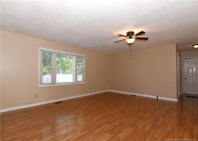 spare room featuring a textured ceiling, hardwood / wood-style floors, and ceiling fan