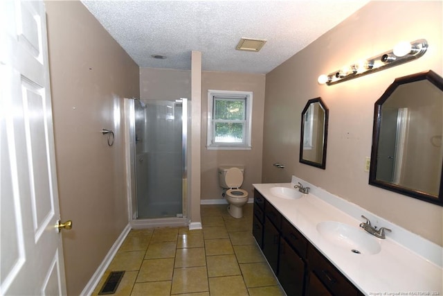 bathroom featuring vanity, a textured ceiling, tile patterned floors, toilet, and a shower with door