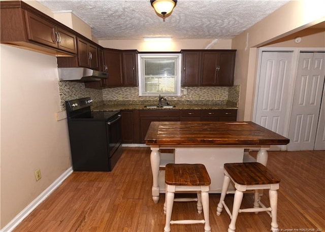 kitchen with a textured ceiling, light hardwood / wood-style floors, black range with electric cooktop, and sink