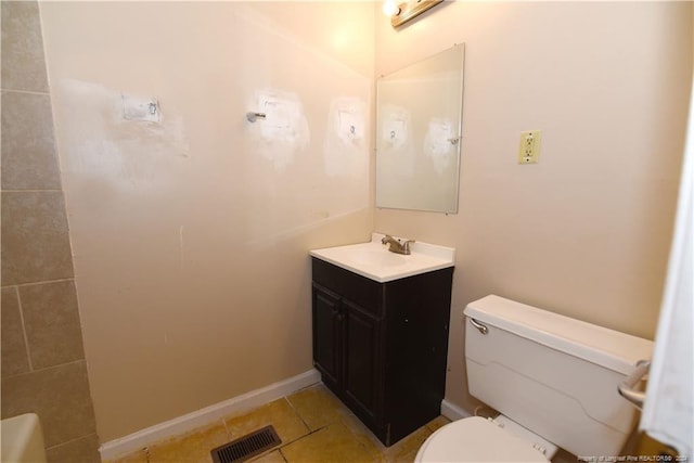 bathroom with vanity, tile patterned flooring, and toilet