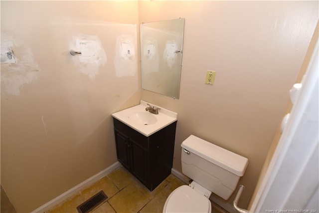 bathroom with vanity, toilet, and tile patterned floors