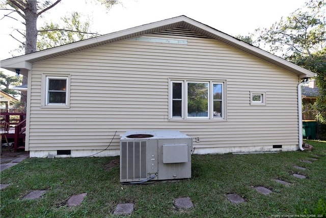 back of house with a lawn and central AC