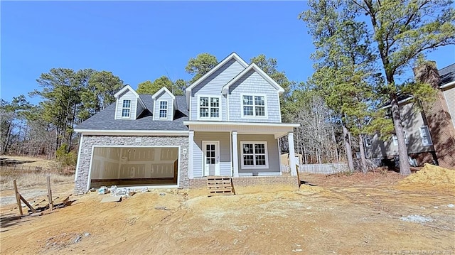 view of front of house featuring a garage and a porch